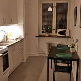 Kitchen and dining table in 1-bdr corporate apartment.