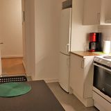 Kitchen and halway in 1-bedroom corporate apartment.